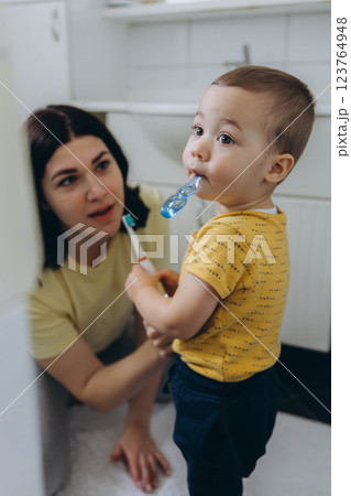 Dental care, mother brushing teeth with boy for wellness,Bathroom, oral health toothbrush 123764948