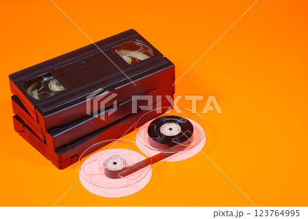 Magnetic tape on reels and VHS videocassettes 123764995