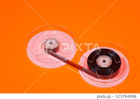 Magnetic tape on reels from a VHS videocassette 123764996
