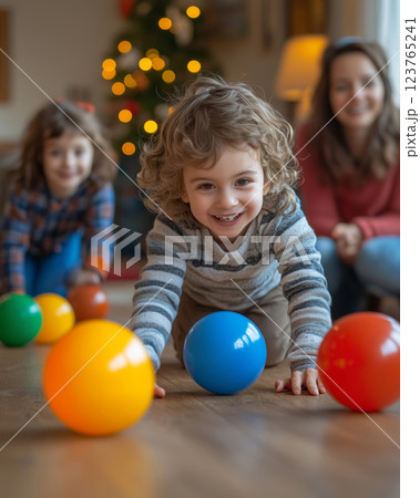 Kids joyfully play ball with their mother in a cozy home environment 123765241