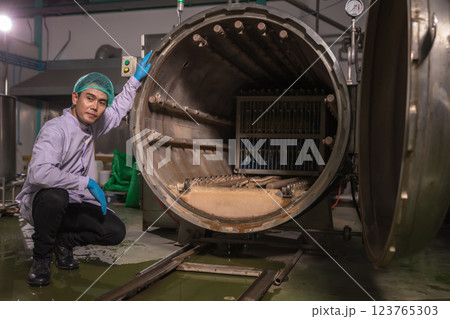 Worker Checking quality or checking stock of glass bottle in beverage factory.  123765303