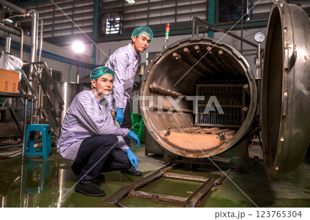 Worker Checking quality or checking stock of glass bottle in beverage factory.  123765304