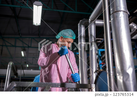 Worker Checking quality or checking stock of glass bottle in beverage factory 123765314