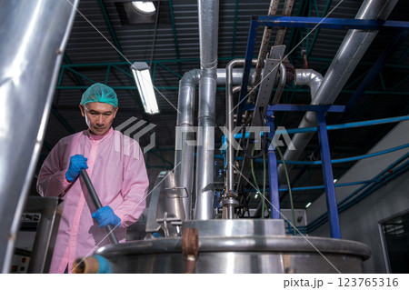 Worker Checking quality or checking stock of glass bottle in beverage factory 123765316