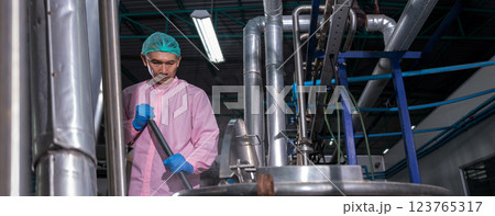 Worker Checking quality or checking stock of glass bottle in beverage factory Worker Checking quality or checking stock of glass bottle in beverage factory 123765317