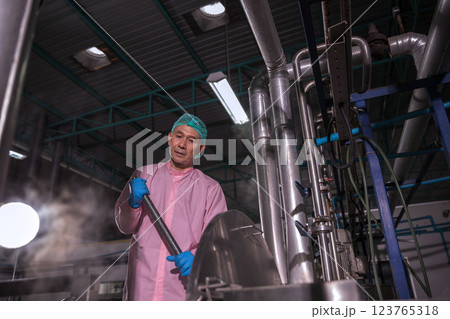 Worker Checking quality or checking stock of glass bottle in beverage factory 123765318