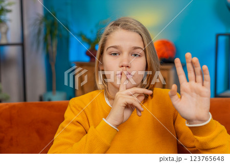 Teenager child boy presses finger to lips makes silence hush sign do not tell gossip secret, quiet Teenager child boy presses finger to lips makes silence hush sign do not tell gossip secret, quiet 123765648