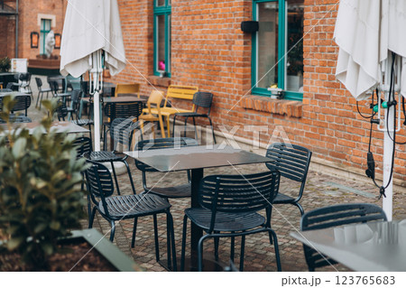 Outdoor cafe seating with tables and chairs Outdoor cafe seating with tables and chairs 123765683