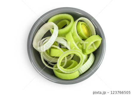 sliced Leek vegetable in ceramic bowl isolated on white background. Top view. Flat lay 123766505