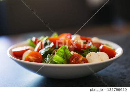 Salad with mozzarella balls tomatoes and mix salad 123766639