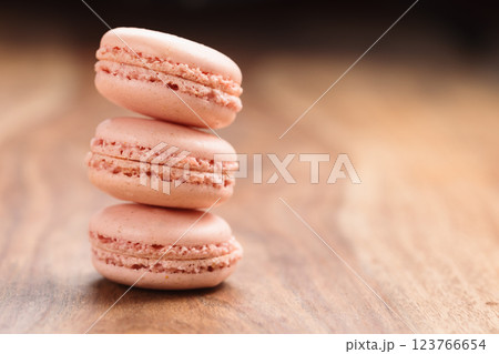 Tender pink color macarons on wood background with copy space Tender pink color macarons on wood background with copy space 123766654