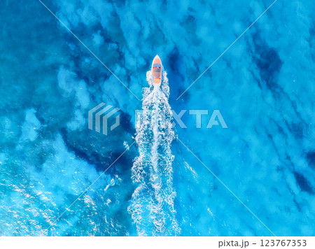 Drone view on fast boat on blue Mediterranean sea at sunny day. Vacation and leisure. Drone view on fast boat on blue Mediterranean sea at sunny day. Vacation and leisure. 123767353