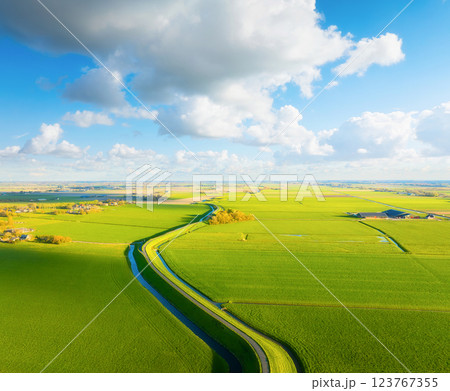Drone view of a road with curves. Road through the field. Image for wallpaper, background, postcard Drone view of a road with curves. Road through the field. Image for wallpaper, background, postcard 123767355