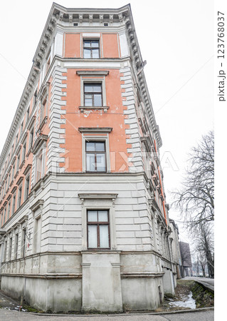 Corner of an Old Residential Building with Exposed Windows and Weathered Facade Corner of an Old Residential Building with Exposed Windows and Weathered Facade 123768037
