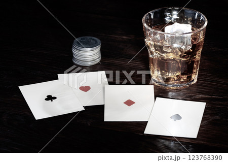 Old West saloon gambling. Four aces playing cards and whiskey. Old West saloon gambling. Four aces playing cards and whiskey. 123768390