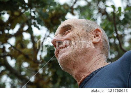 Elderly Man Smiles Talking With His Friend In The Natural Park Elderly Man Smiles Talking With His Friend In The Natural Park 123768628