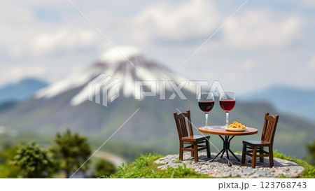 富士山を背景にミニチュアの食べ物とテーブルと椅子が置いてある 123768743