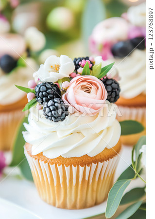 Elegant cupcake with floral decoration and fresh berries. 123768897