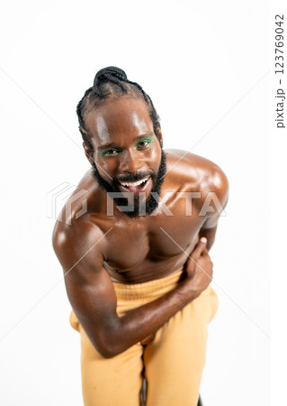 Happy shirtless gay model bending while posing Happy shirtless gay model bending while posing 123769042