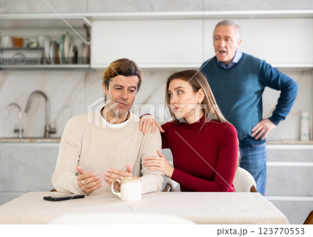 Elderly man quarreling with man and woman couple 123770553
