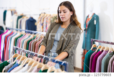 Young woman shopping casual clothes in store Young woman shopping casual clothes in store 123770603