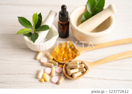 Alternative medicine herbal organic capsule with vitamin E omega 3 fish oil, mineral, drug with herbs leaf natural supplements for healthy good life. 123772612