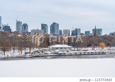 View of Boston skyline and skyscrapers in winter seen behind Charles River from Longfellow Bridge that covered in ice and snow 123772683