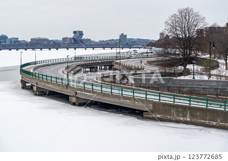 Curve road by the edge of Charles River seen from Long Fellow Bridge in Boston, MA duing winter, Charles River covered in snow and ice Curve road by the edge of Charles River seen from Long Fellow Bridge in Boston, MA duing winter, Charles River covered in snow and ice 123772685