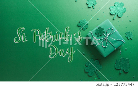 Happy St Patrick's Day decoration concept made from shamrocks ( clover leaf), gift box and leprechaun hat on green background. 123773447