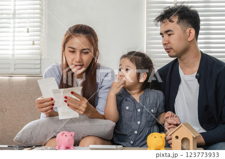 Family budgeting session with child, discussing bills and savings Family budgeting session with child, discussing bills and savings 123773933