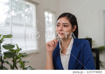 Thoughtful businesswoman accountant reflecting on financial decisions in her office. 123774065