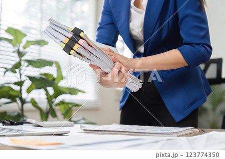 Close-up of accountant organizing tax documents in a professional office Close-up of accountant organizing tax documents in a professional office 123774350
