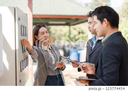 Collaborative sustainable initiatives. Business professionals engaged in discussing green solutions in an open-air meeting. 123774454