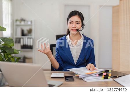 Accountant providing financial consultation via headset in a modern office. 123774470