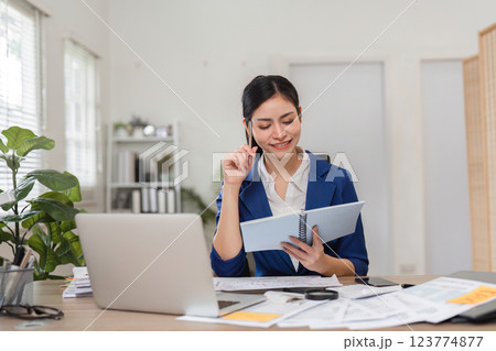Confident businesswoman pondering over financial strategies in her office Confident businesswoman pondering over financial strategies in her office 123774877