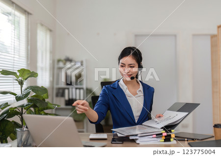 Professional accountant assisting clients via video call, showcasing expertise in finance and tax preparation. 123775004