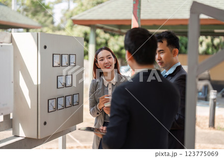 Dynamic sustainable strategy discussion. Diverse professionals collaborating on eco-friendly business practices in an outdoor setting. 123775069