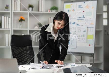 Accountant engaged in financial analysis and document review. 123775127