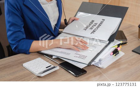 Accountant organizing financial reports and tax documents for clients 123775131