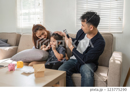 Family sharing financial knowledge and savings tips with their daughter Family sharing financial knowledge and savings tips with their daughter 123775290