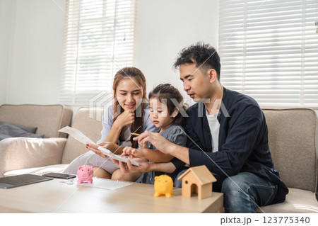 Family budgeting session with a focus on savings and financial education. Family budgeting session with a focus on savings and financial education. 123775340