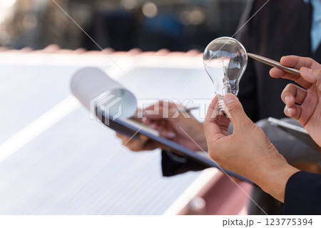 Sustainable business. Professionals analyzing energy solutions with focus on teamwork. 123775394