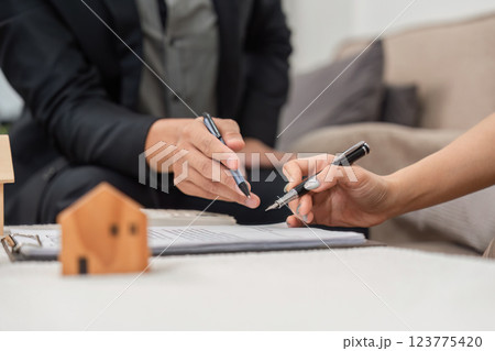 Real Estate Planning. Individuals negotiating terms of property agreement with documents on the table. 123775420