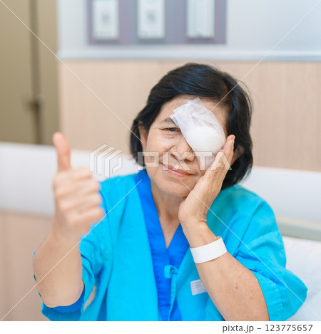 Elderly Woman with eye protective shield after eye surgery. Eye disease, Cataract,  Glaucoma, Age Related Macular Degeneration, Diabetic Retinopathy, Vitreous, Lasik, World Glaucoma day and health 123775657