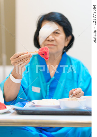 Senior Woman eating food after eye surgery in hospital . Eye disease, Cataract,  Glaucoma, Age Related Macular Degeneration, Diabetic Retinopathy, Lasik, World Glaucoma day and health treatment 123775664