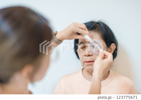 Senior Woman during eye protecting by shield after eye surgery. Eye disease, Cataract,  Glaucoma, Age Related Macular Degeneration, Diabetic Retinopathy, Vitreous, Lasik, World Glaucoma day and health 123775671