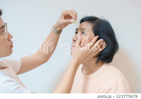 Elderly Woman use ophthalmic solutions or Eye Drops after eye surgery. Eye disease, Cataract,  Glaucoma, Age Related Macular Degeneration, Diabetic Retinopathy, World Glaucoma day and health treatment 123775679