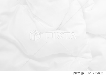 Close up top view of white bedding sheet and wrinkle messy blanket in bedroom after wake up in the morning. 123775893