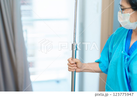Senior asian Patient Woman walking and recovering in hospital. Female Elderly resting after surgery and cure. Illness, treatment, Insurance, Health care and medical, world day of Sick and Health day 123775947