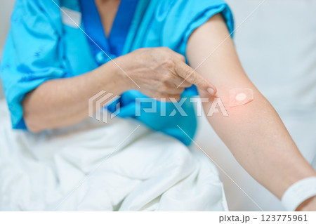 Elderly asian Patient Woman with medical patch plaster after blood test in hospital. Diagnose, illness, treatment, Insurance, Healthcare, medical Examination, Blood donation and World Blood Donor Day 123775961